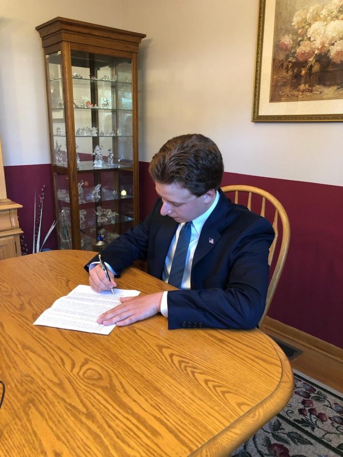 Senior Student, Nick Mattei Stamps his Signature on own Letter to Send to Representatives 